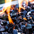 The illusion effect of flames "melting" midnight black fire glass