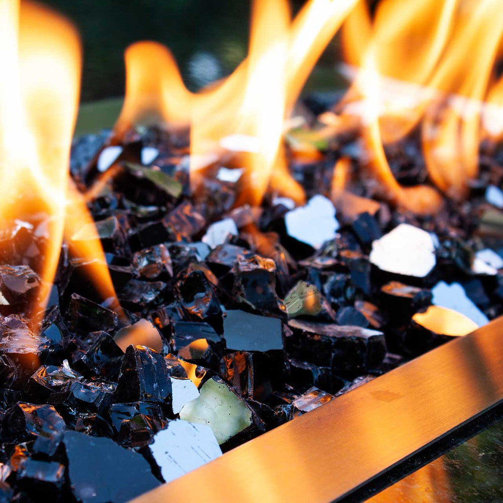 Medium view of flames reflecting atop ebony mirror-coated fire glass in a fire pit