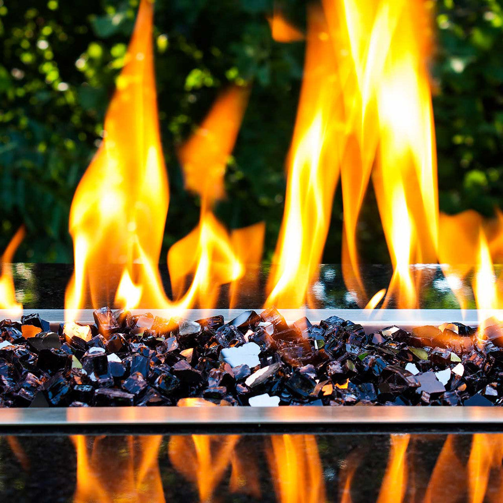Wide view of flames blazing across sea of jet-black fire glass